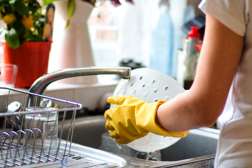 Caregiver washing dishes